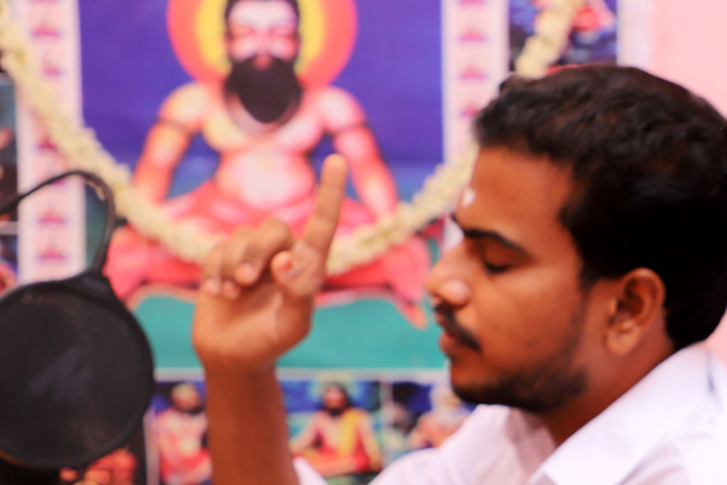 Fore: Translator Saba during a Palm leaf horoscope reading. Behind: Sri Agastya