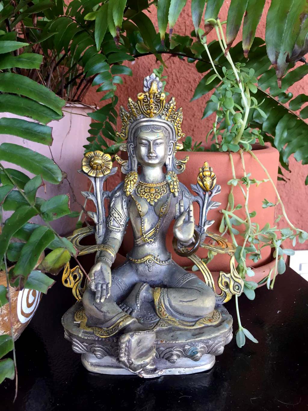 Green Tara statue, a personification of compassion worshipped in puja.