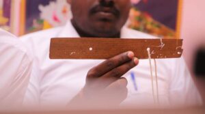 palm leaf reader holding palm leaf