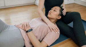 woman lying on a yoga mat