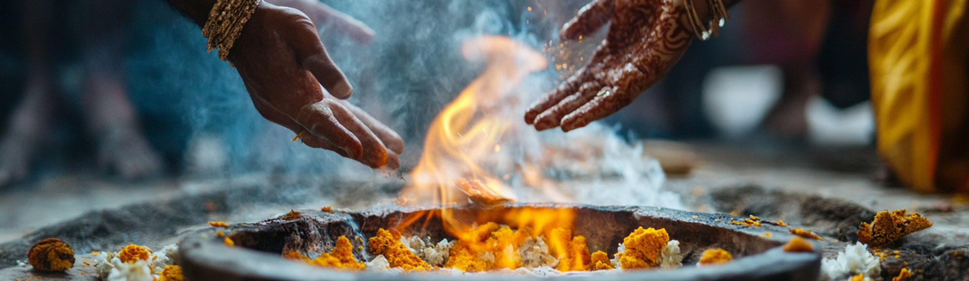 Hands held over the sacred fire during a Hindu homa fire ceremony