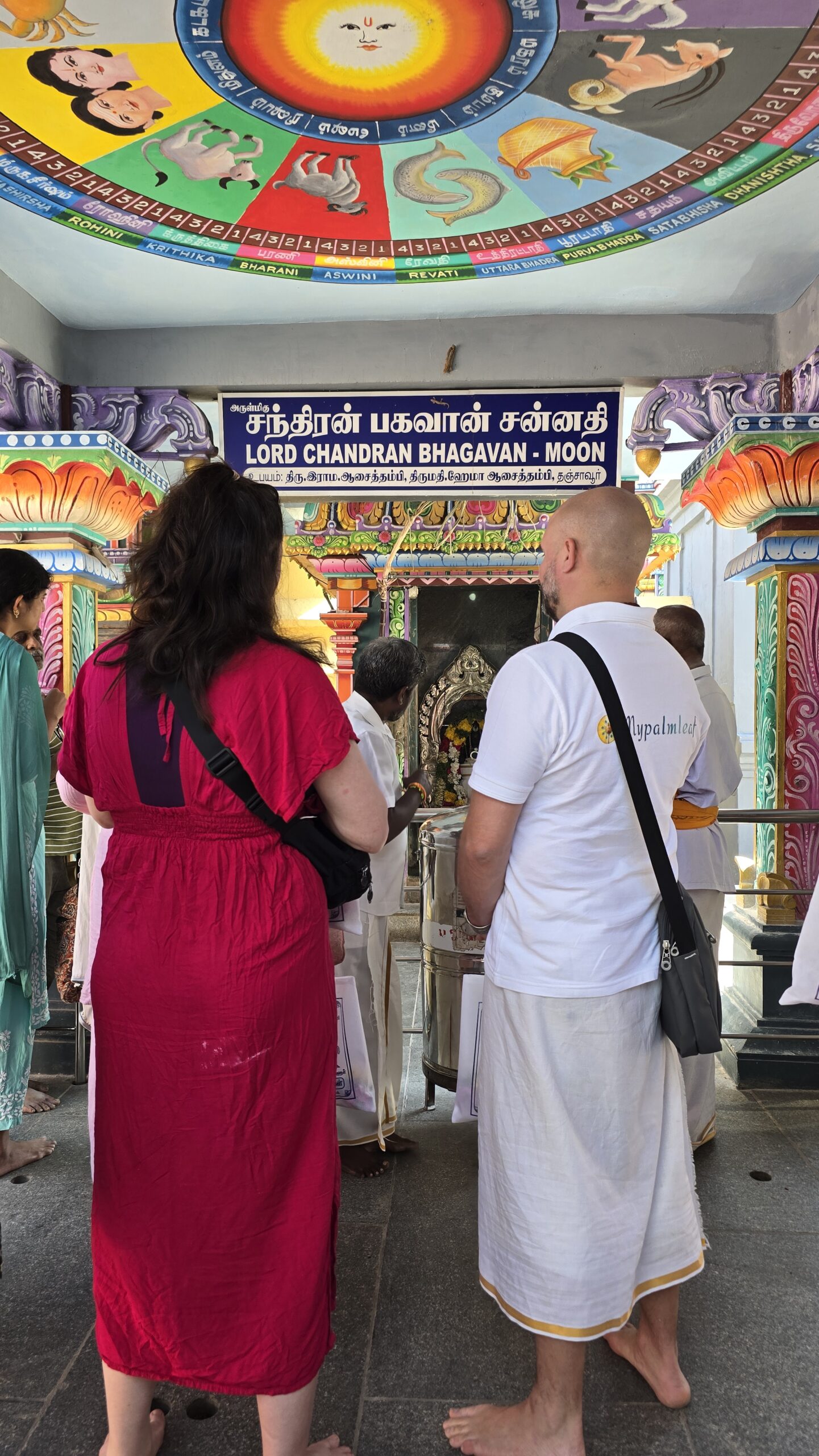 Couple at the Lord Chandran (Moon) shrine inside a Navagraha temple