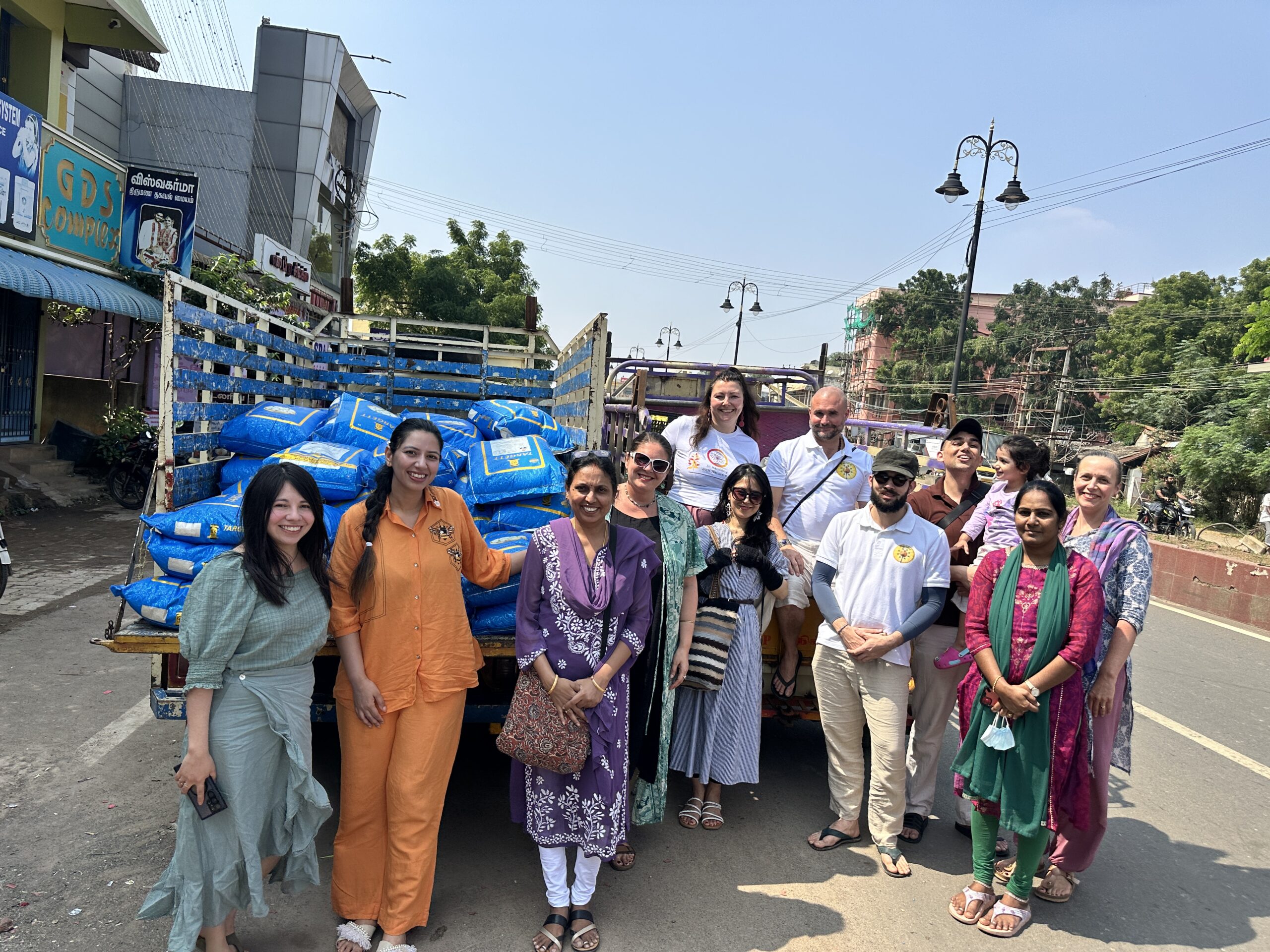Mypalmleaf team beside a truck of donated supplies during a charity drive in India