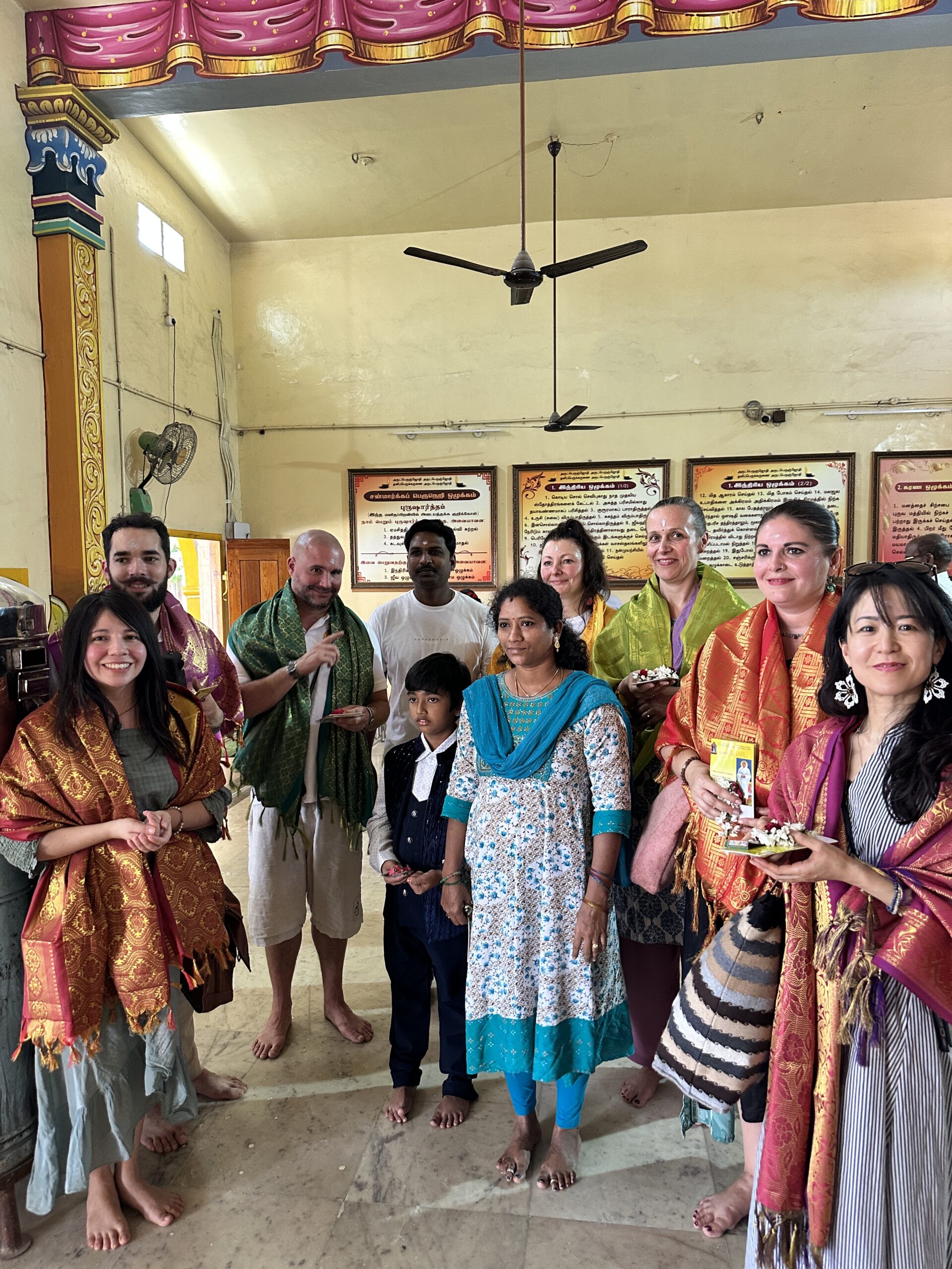 Mypalmleaf group honored with shawls alongside a local family in a temple hall