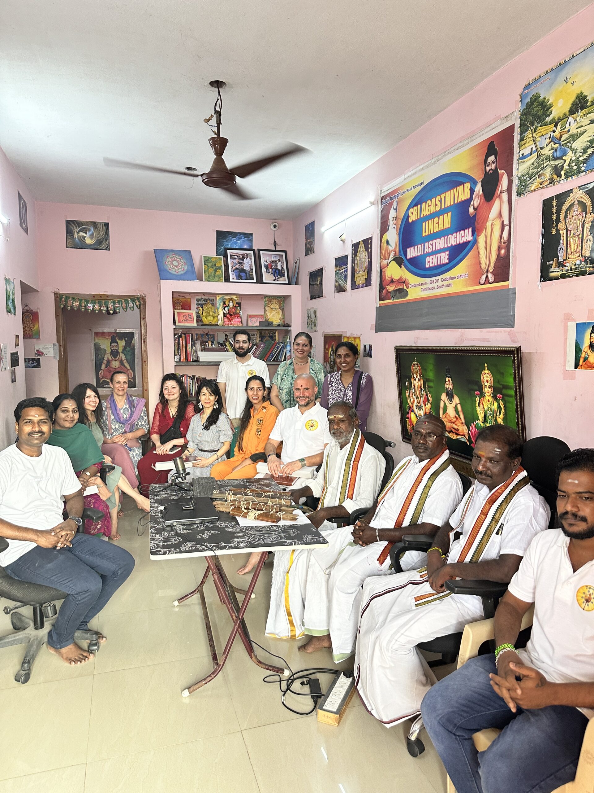 Mypalmleaf group with Nadi readers and palm leaf bundles at a South Indian astrology centre