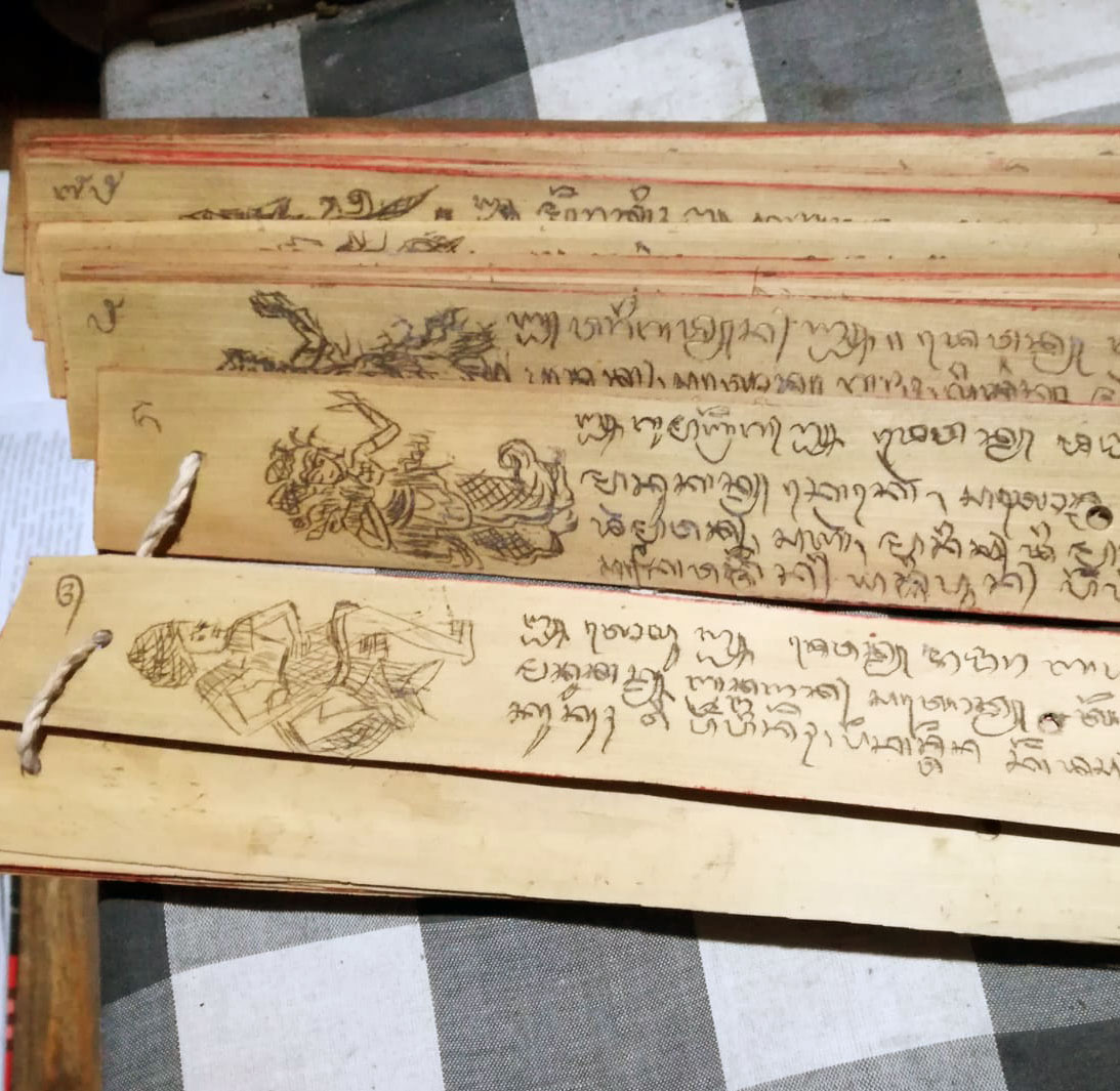 Close-up of a palm leaf inscribed with old Tamil script in Naadi Shastra