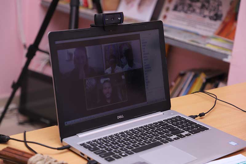 Laptop showing an online palm leaf reading video call at the reading centre