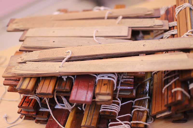 Pile of bundled ancient palm leaf manuscripts