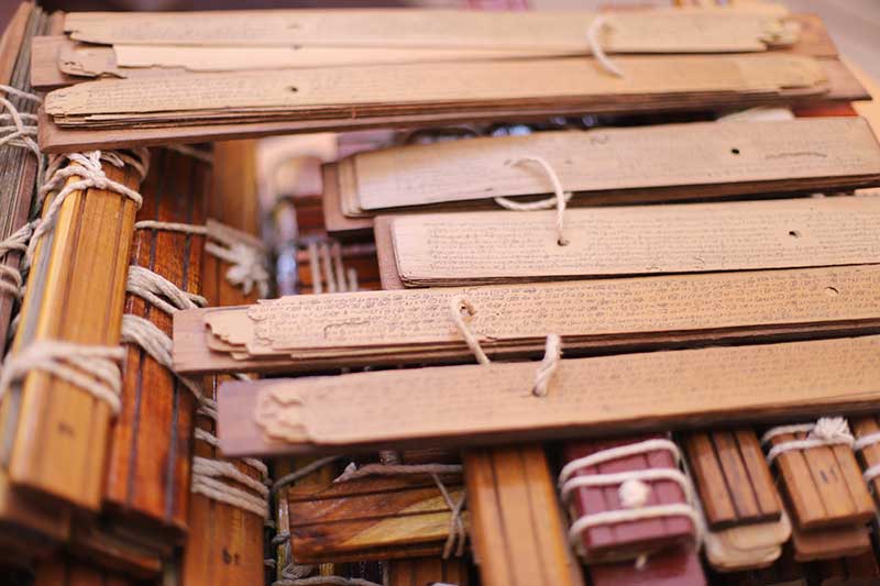A pile of inscribed ancient palm leaf manuscripts in an archive