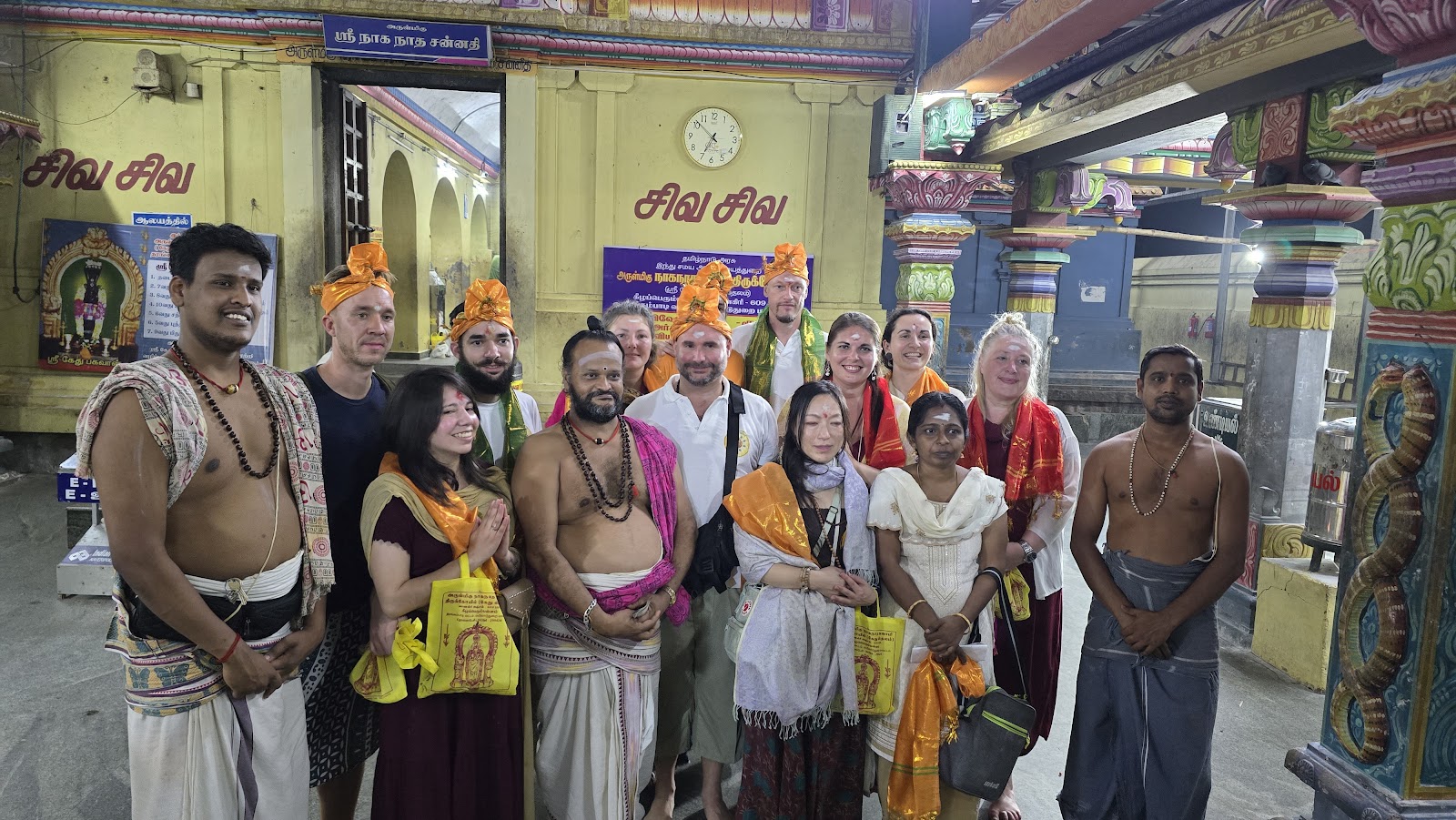 Mypalmleaf group with priests at a Shiva temple in the evening